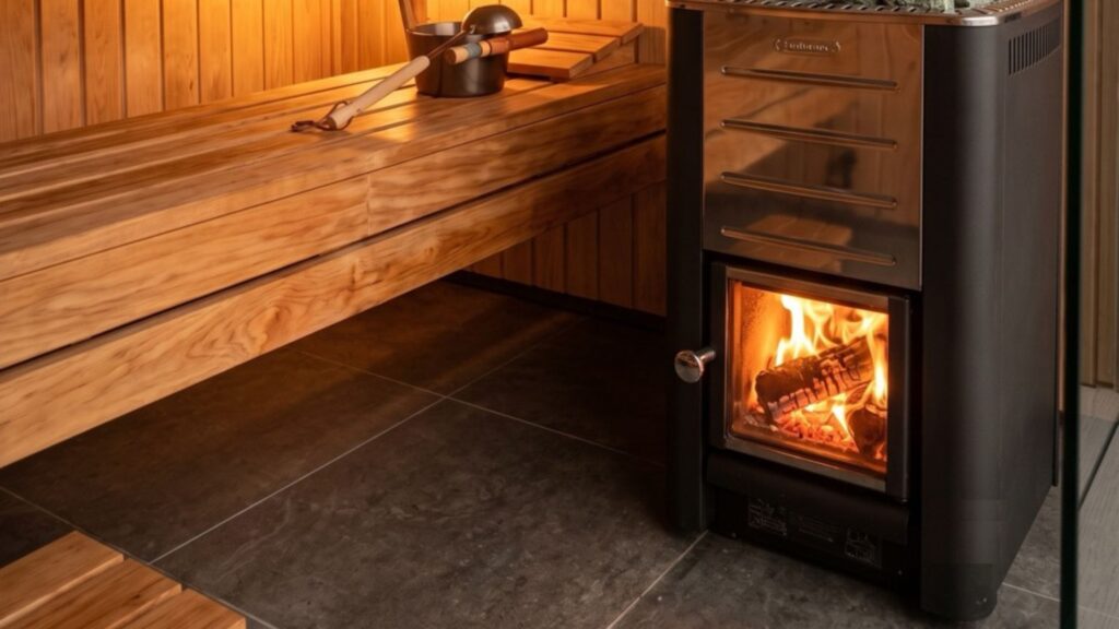 Wood-burning stove inside a private sauna, flames visible through the glass