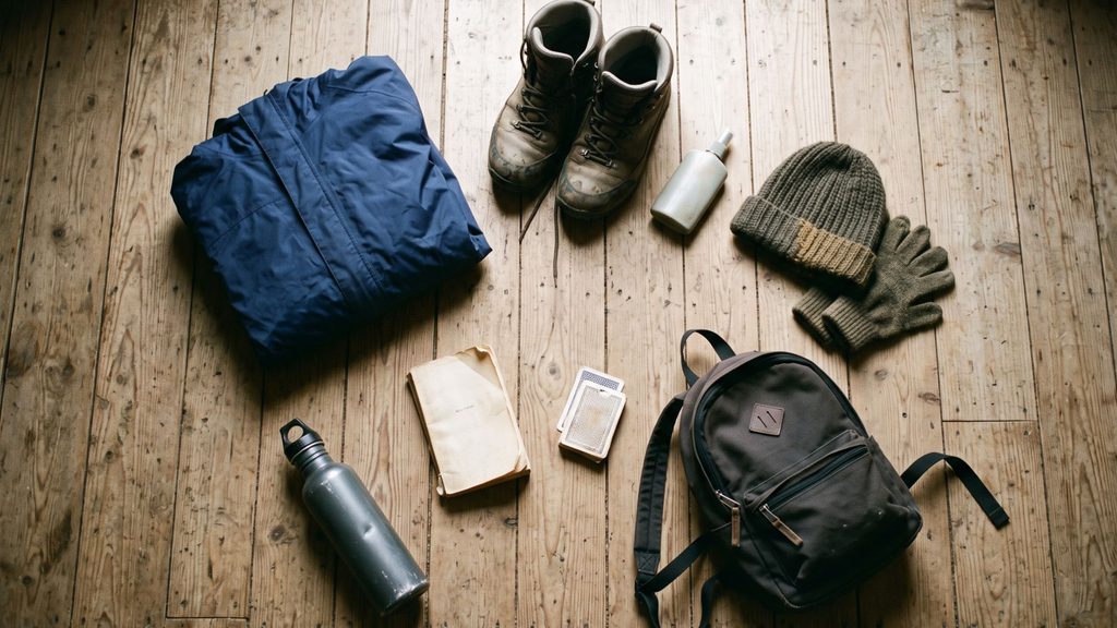 Waterproofs and boots ready on the Loch Katrine shore path, showing what to pack for a self-catering holiday in Scotland